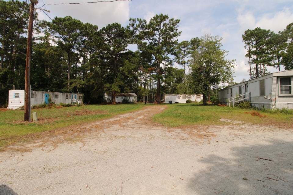 small home at end has been used for storage, but still has fixtures for home