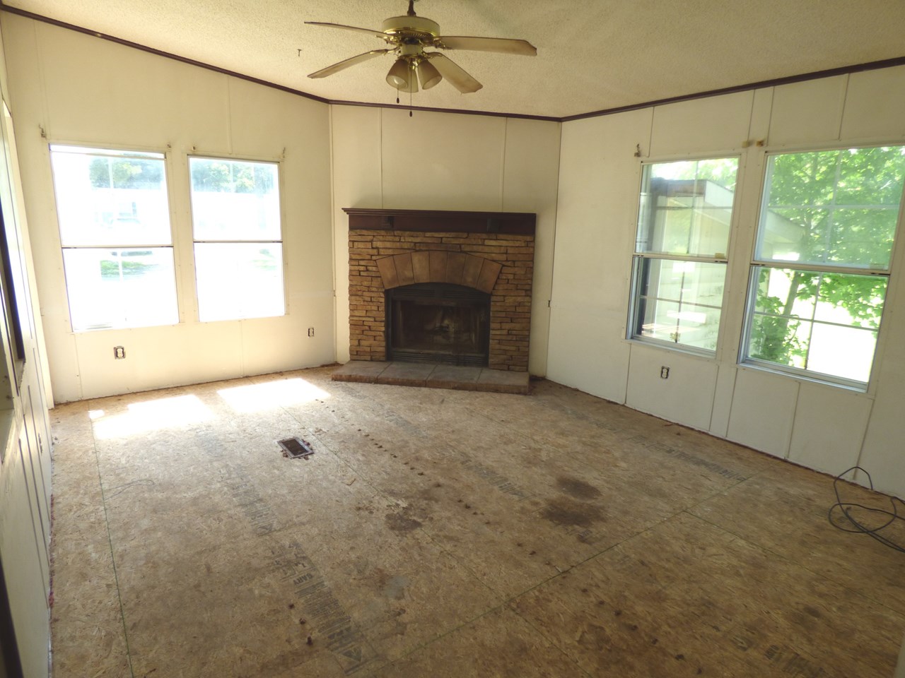 older pic of family room with fireplace (non-working, chimney capped off)