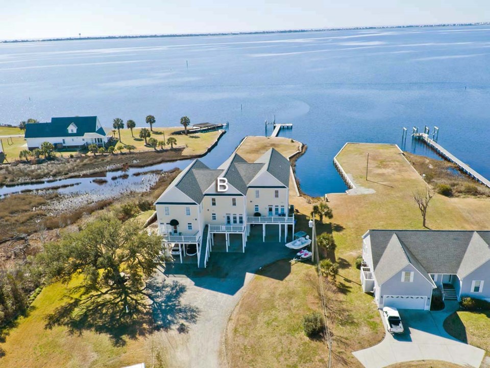 drone view of condo 3 condos in building. unit being offered is b in center. paradise for the boat lover!