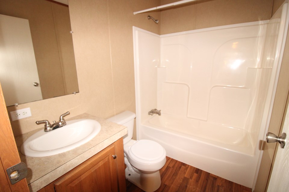 hall bathroom hall bath by bedrooms 2 & 3. flooring replaced with tile-look lvp.