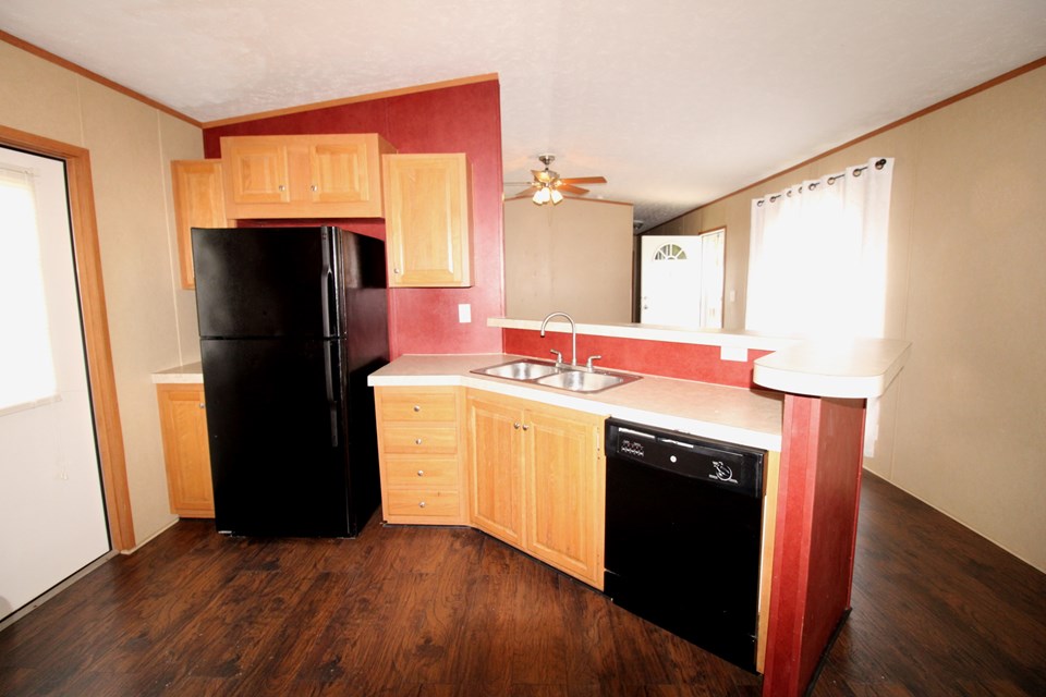 kitchen open to living room, but separated by breakfast bar. again, the red walls have been painted tan.