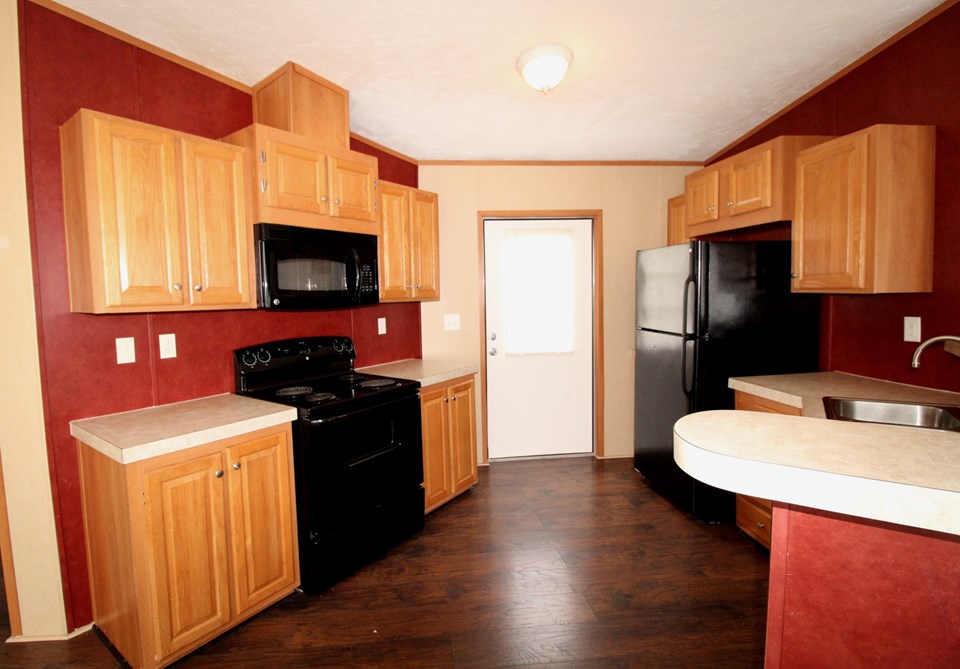 kitchen includes dishwasher, refrigerator, stove and microwave hood